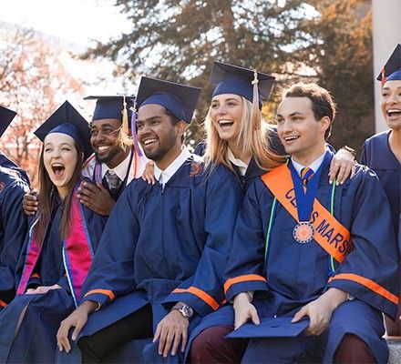 Graduates sitting on the steps of Hendricks Chapel