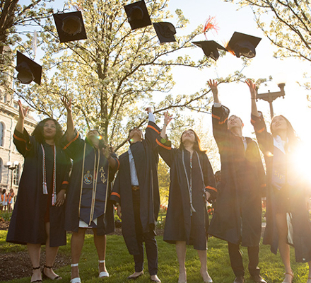 Graduates tossing their hats outdoors